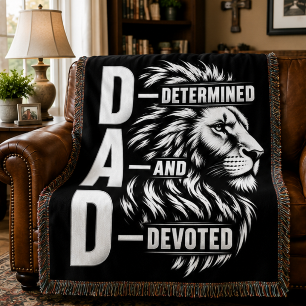 DAD Determined and Devoted lion woven blanket displayed on a leather chair